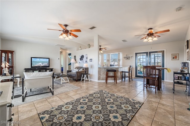 living room with ceiling fan and light tile patterned floors