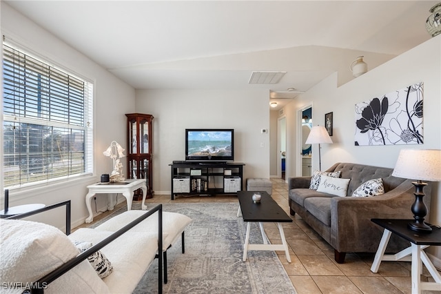 tiled living room featuring lofted ceiling