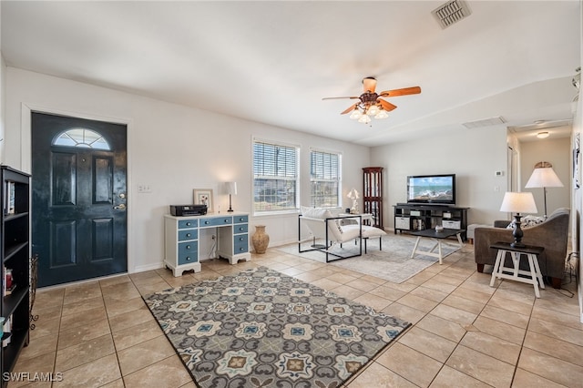 tiled living room featuring ceiling fan