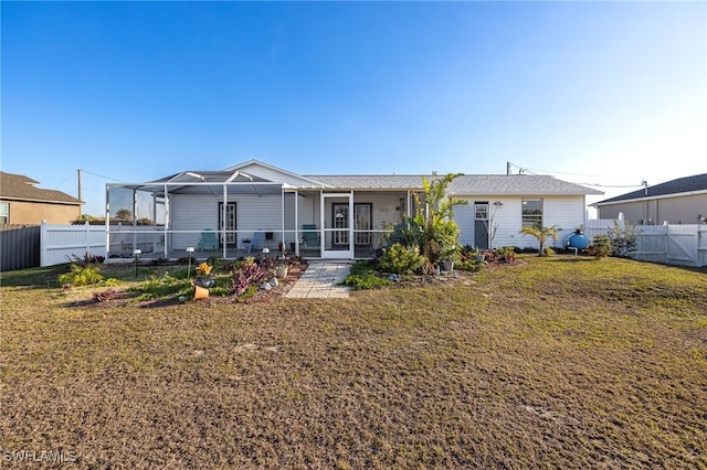 back of property featuring a yard and a lanai