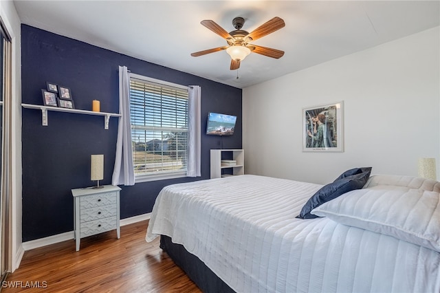 bedroom with hardwood / wood-style floors and ceiling fan