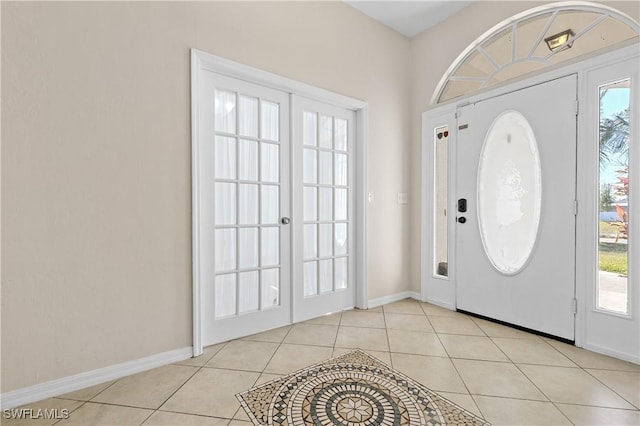 tiled entryway featuring french doors