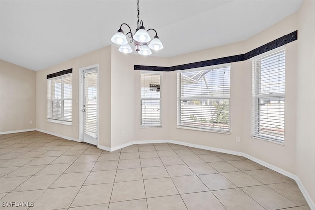 unfurnished dining area with a notable chandelier and vaulted ceiling