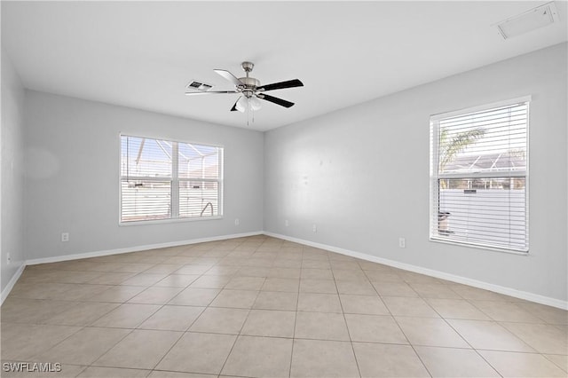 spare room with a wealth of natural light and ceiling fan