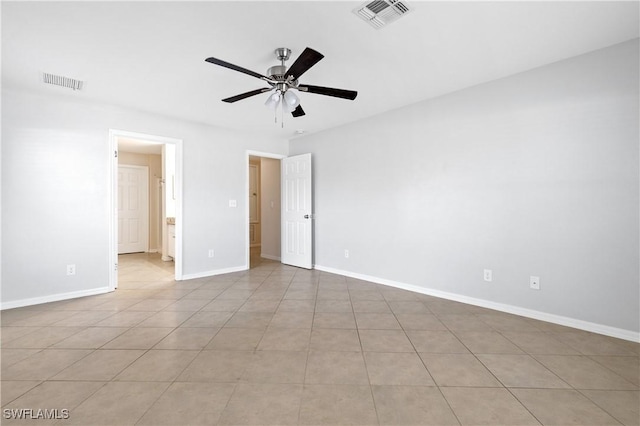 tiled empty room with ceiling fan