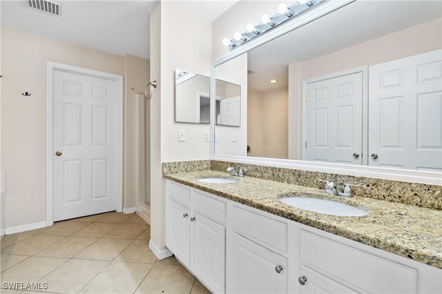 bathroom with tile patterned flooring and vanity