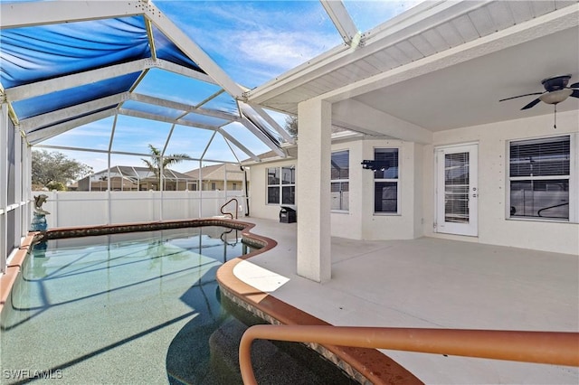 view of swimming pool with a patio and glass enclosure