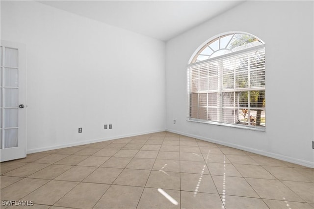 tiled empty room featuring plenty of natural light