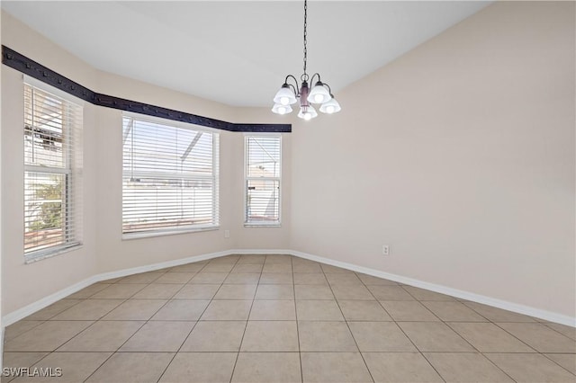 unfurnished room featuring lofted ceiling and a chandelier