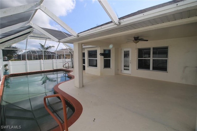 view of pool with a lanai, ceiling fan, and a patio area