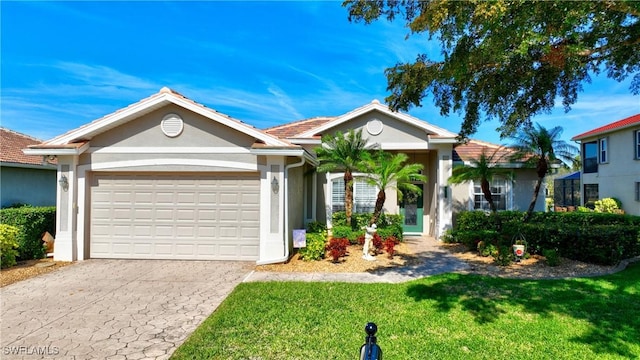 ranch-style house featuring a garage and a front lawn