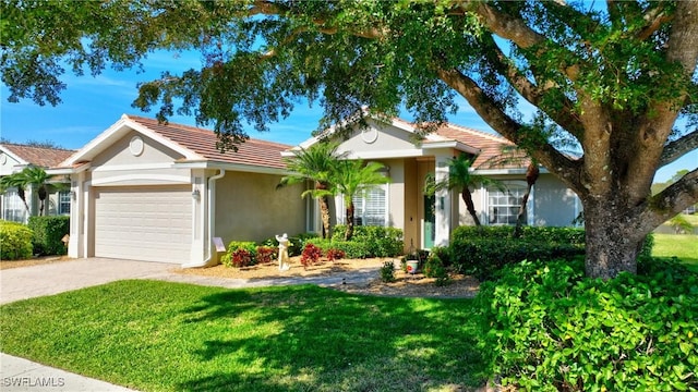 ranch-style home with a garage and a front yard