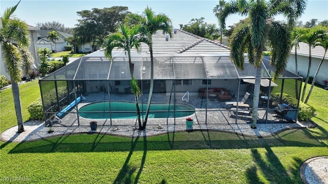 view of pool featuring a lawn, a patio, and glass enclosure