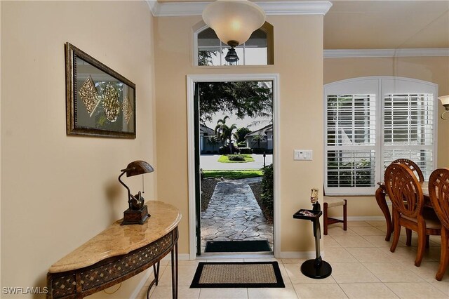 entrance foyer with crown molding and light tile patterned flooring