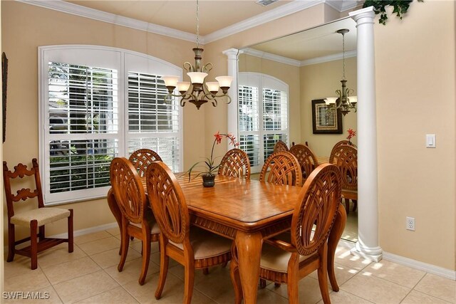 dining area with crown molding, a chandelier, light tile patterned flooring, and ornate columns