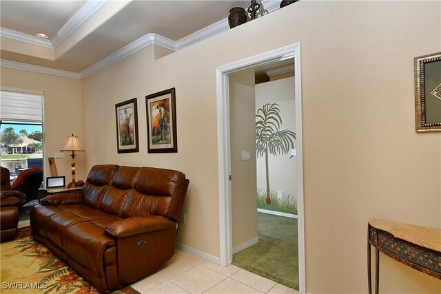 tiled living room featuring ornamental molding and a raised ceiling