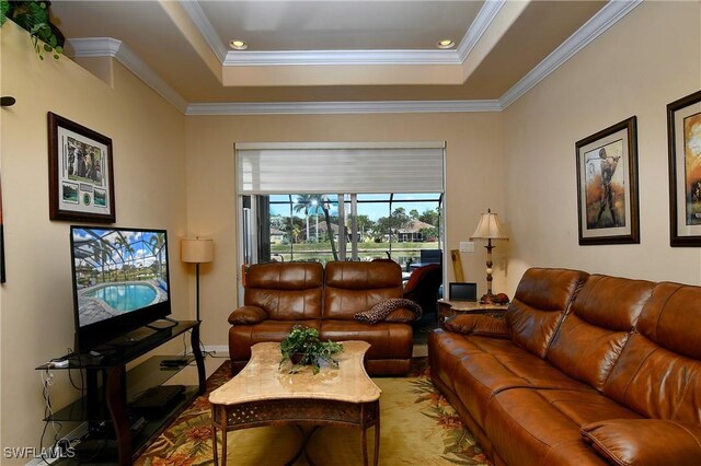 living room with crown molding and a tray ceiling