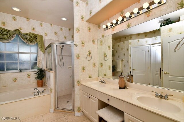 bathroom with tile patterned flooring, vanity, and separate shower and tub