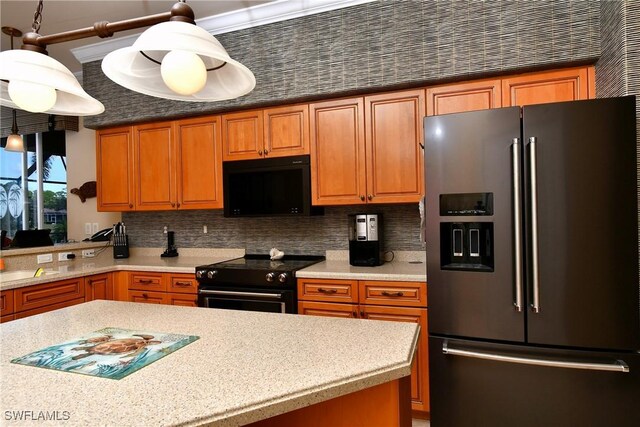 kitchen with pendant lighting, decorative backsplash, and black appliances