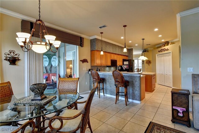 tiled dining area with ornamental molding and a chandelier