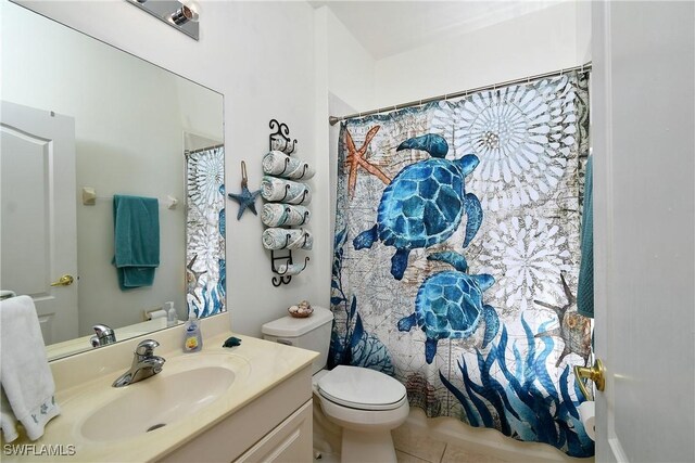 bathroom with vanity, tile patterned floors, and toilet