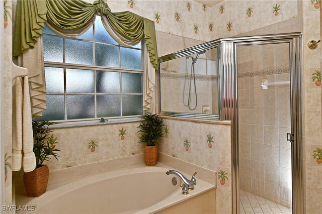 bathroom featuring separate shower and tub