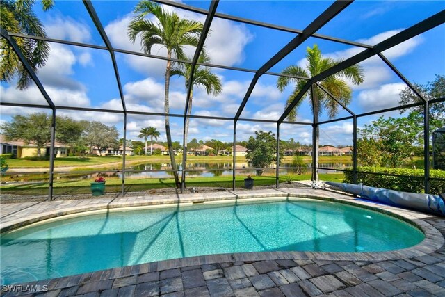 view of pool with a water view, a lanai, and a patio