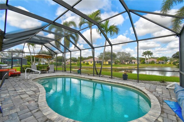 view of swimming pool with a lanai, a patio area, and a water view