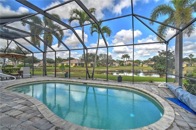 view of swimming pool featuring a water view, a patio area, and glass enclosure