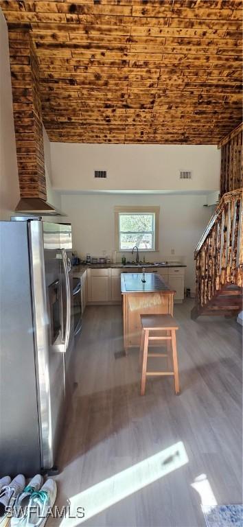 interior space featuring hardwood / wood-style floors, brick ceiling, and sink