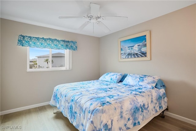 bedroom with ceiling fan and hardwood / wood-style floors