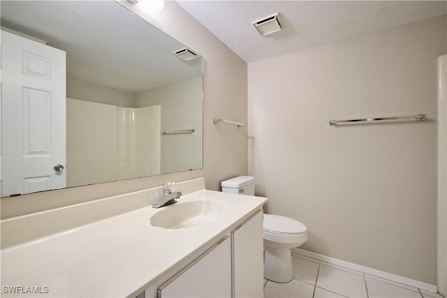 bathroom featuring vanity, walk in shower, tile patterned floors, and toilet