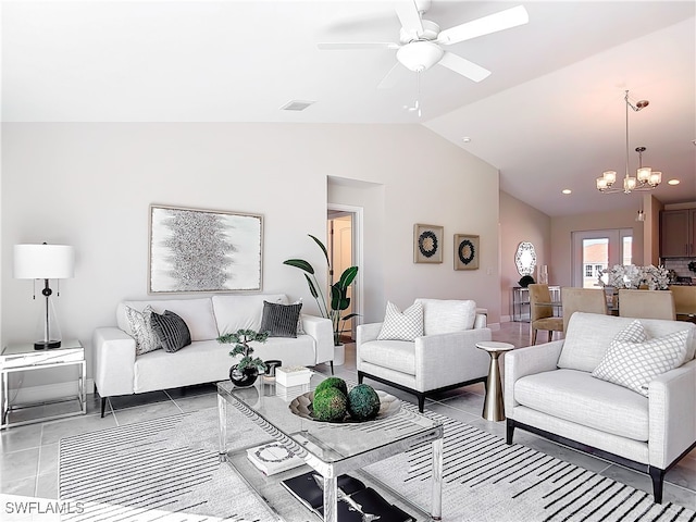 tiled living room with ceiling fan with notable chandelier, lofted ceiling, and visible vents