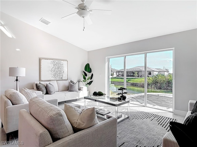 living room with lofted ceiling, baseboards, ceiling fan, and visible vents