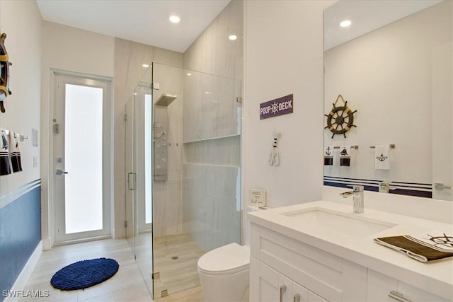 bathroom with vanity, walk in shower, and toilet