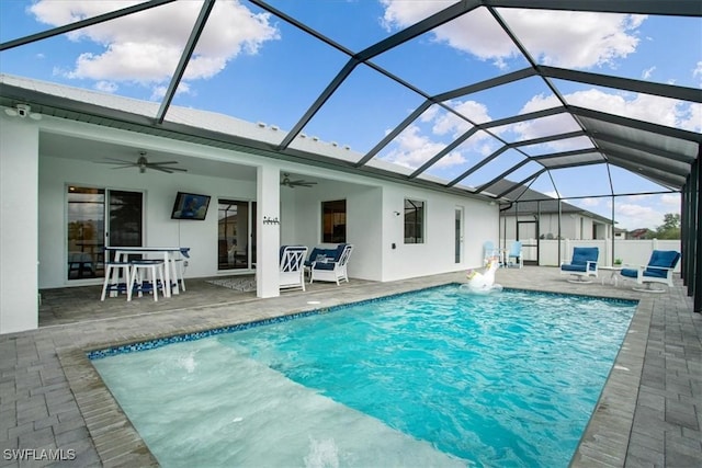 view of pool featuring ceiling fan, glass enclosure, and a patio