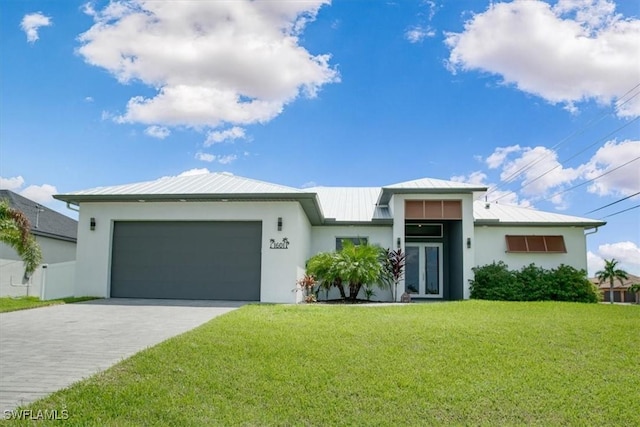 view of front of property featuring a garage and a front lawn