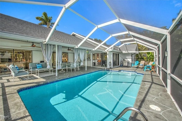 view of swimming pool featuring a patio, a lanai, and ceiling fan