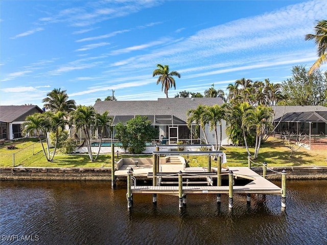 dock area with a water view, glass enclosure, and a lawn