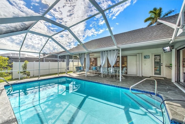 view of pool with a lanai and a patio