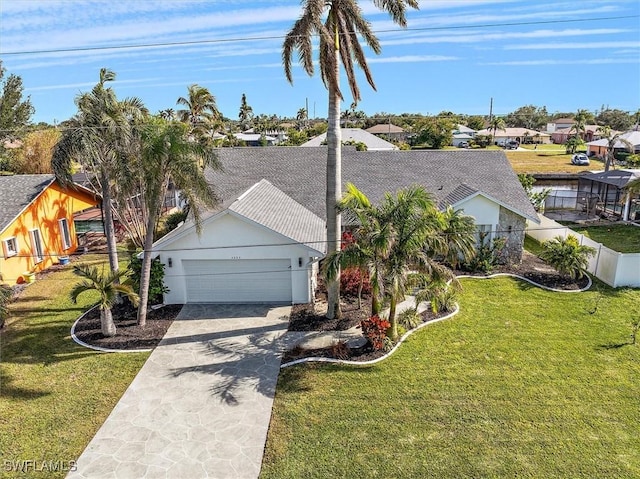 view of front of home featuring a garage and a front lawn