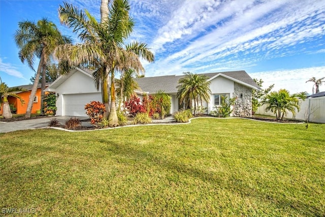 ranch-style house featuring a garage and a front yard