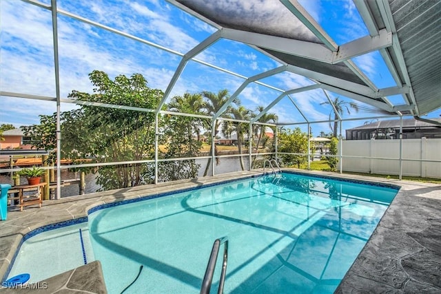 view of pool featuring a water view and glass enclosure