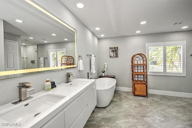 bathroom with a healthy amount of sunlight, vanity, and separate shower and tub