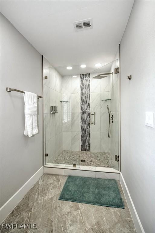 bathroom with a shower with shower door