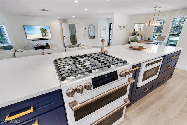 kitchen featuring an inviting chandelier, white appliances, decorative light fixtures, and light hardwood / wood-style flooring