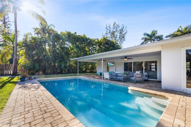 view of pool with an outdoor hangout area, ceiling fan, and a patio area