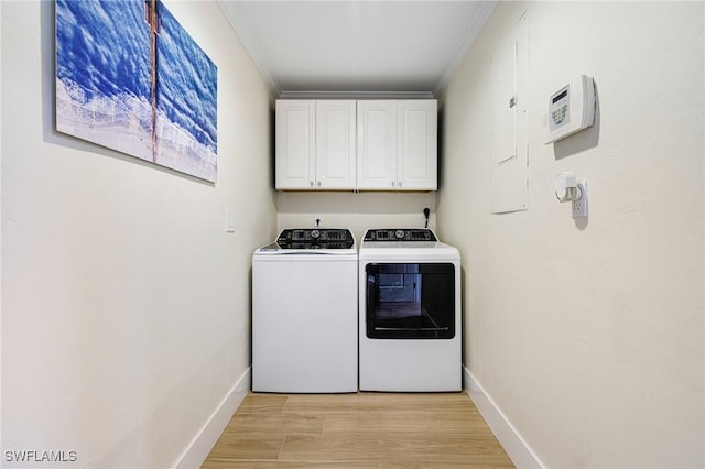 laundry room with cabinets, independent washer and dryer, ornamental molding, and light hardwood / wood-style flooring