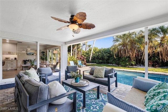 sunroom featuring ceiling fan