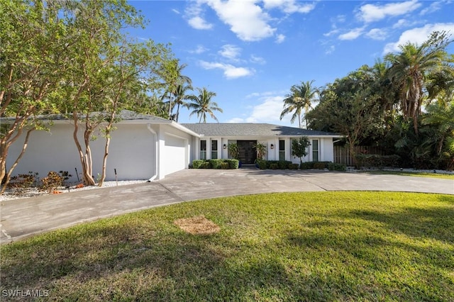 ranch-style house featuring a garage and a front yard